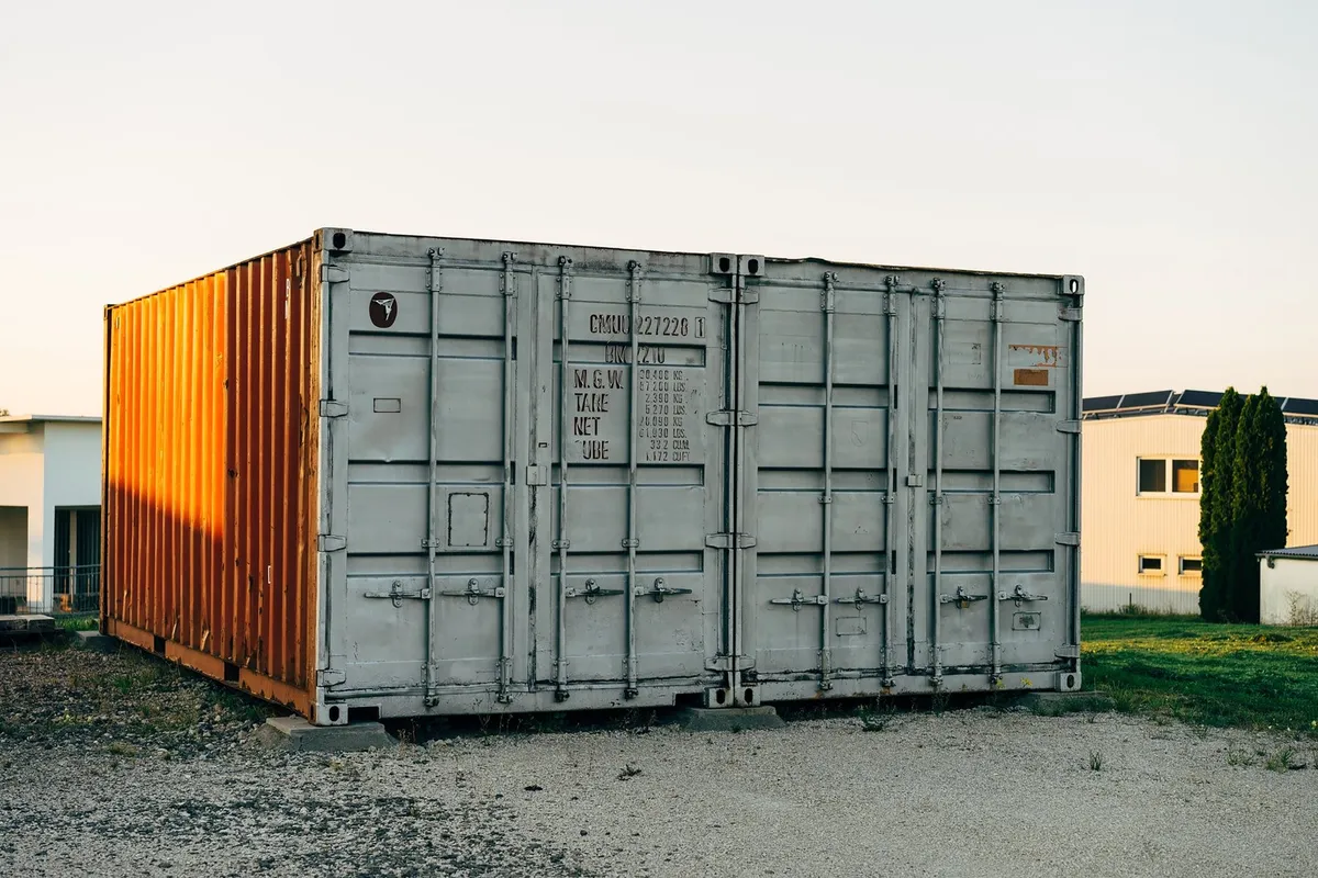 A metal shipping container at a storage facility, highlighting the practicality of one trip shipping containers.